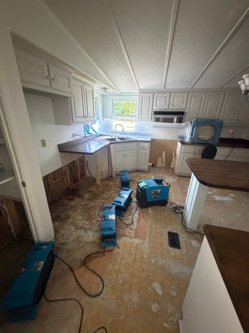 Before: Damaged flooring removed and the kitchen dried out