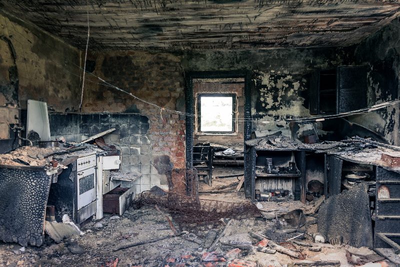 The charred interior of a fire damaged room before restoration