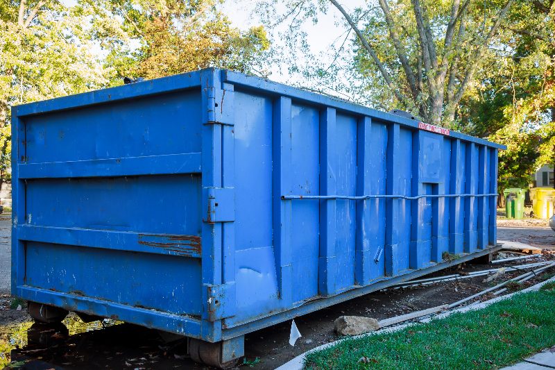 A debris dumpster staged for a fire damage cleanup