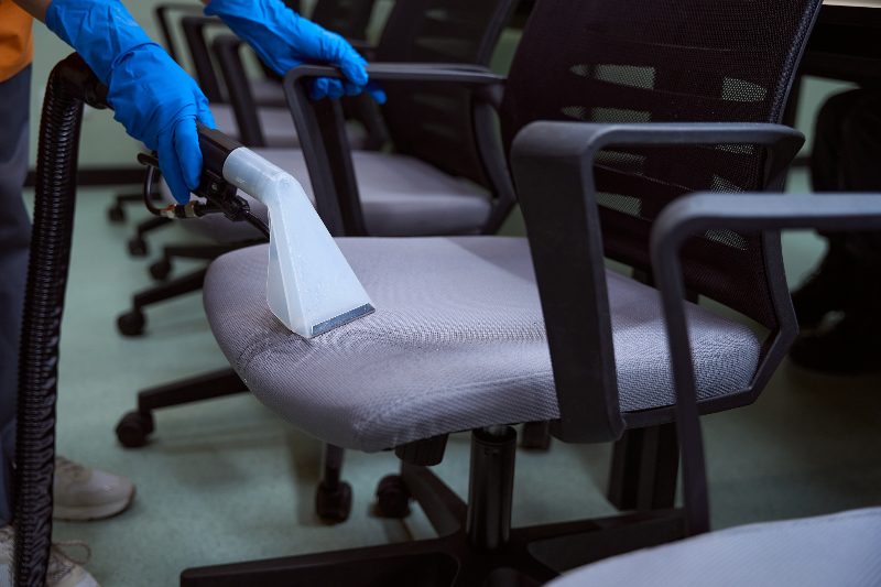 Office chair upholstery being deep cleaned with an extraction tool