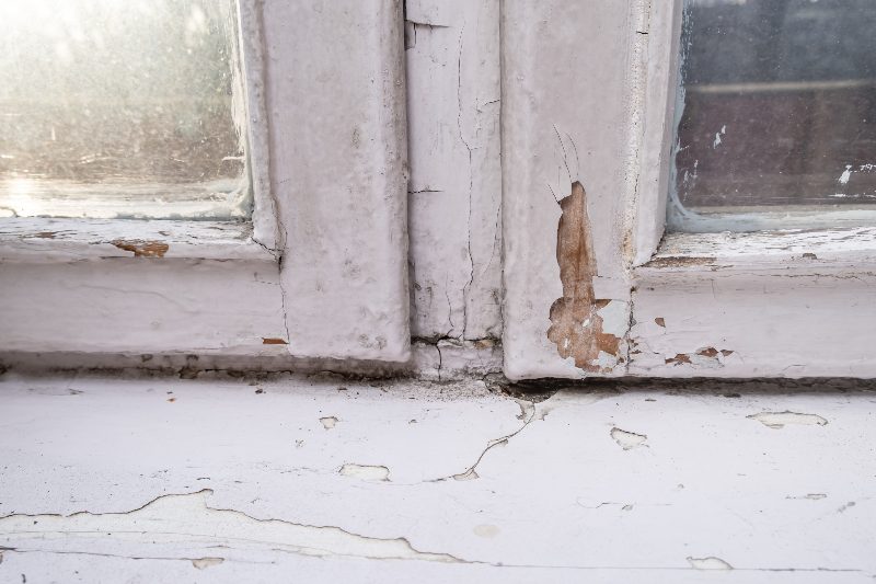 Peeling and cracked lead paint on a window sill