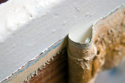Layers of old lead paint on a painted surface