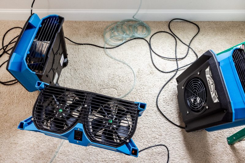 Air movers running on carpet during structural drying