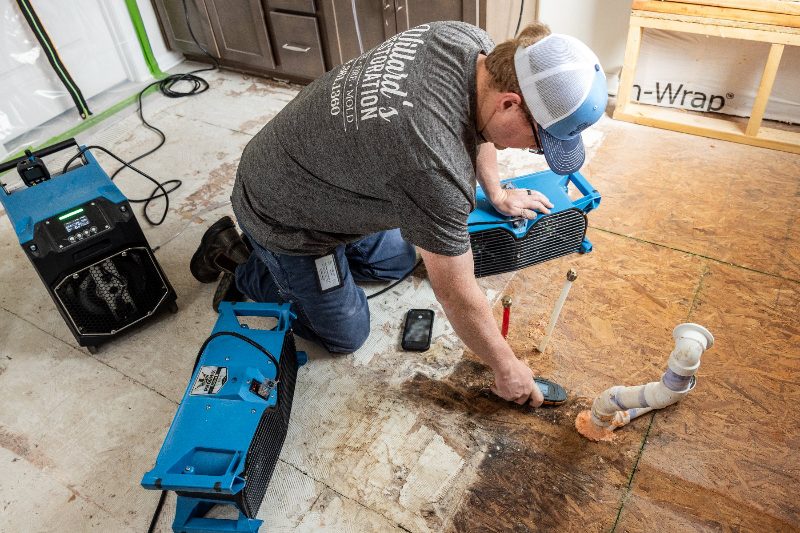 Willard's Restoration technician drying a water damaged floor